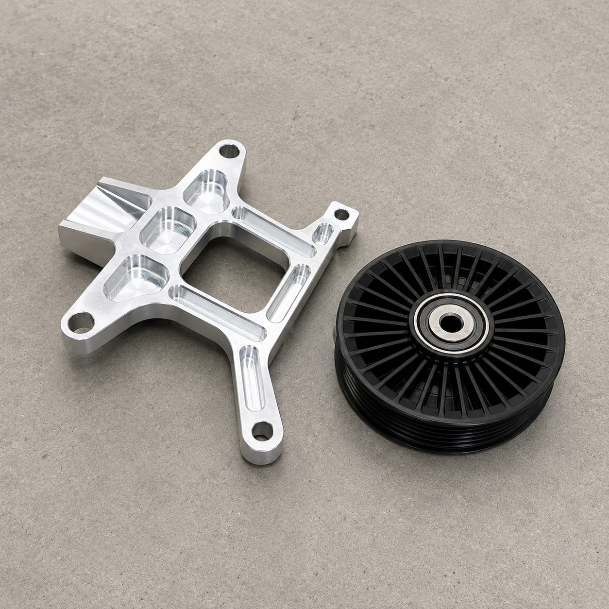Lightweight GR Yaris AC delete bracket with CNC-machined weight reduction pockets and pulley