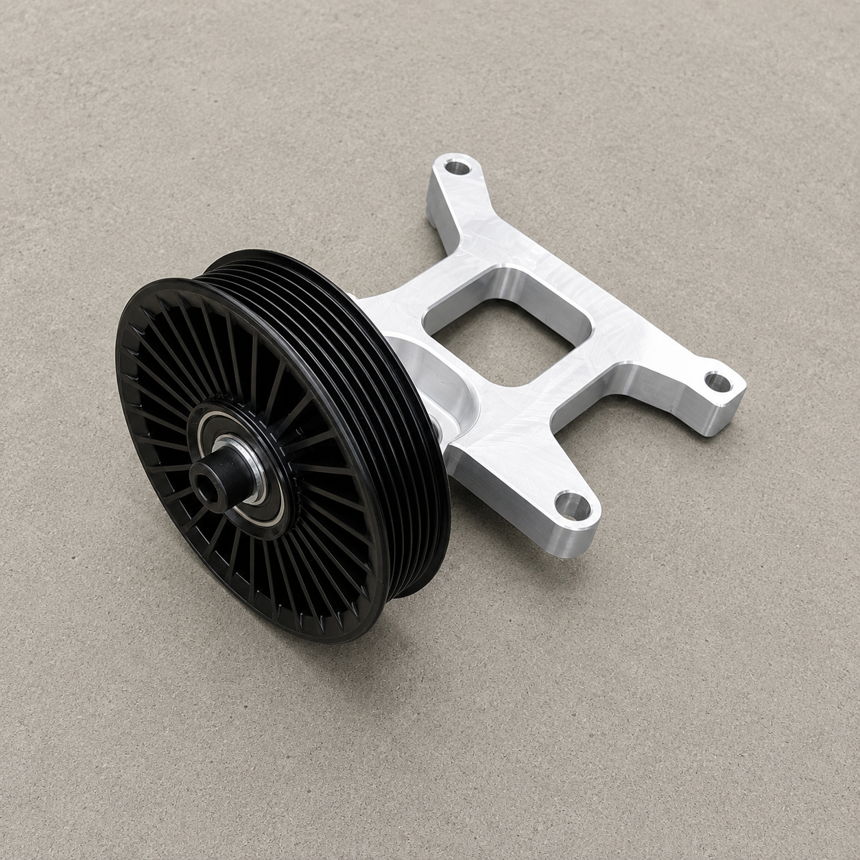 Assembled GR Yaris AC delete kit showing aluminium bracket and auxiliary belt pulley