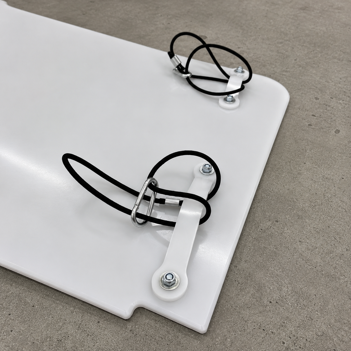 GR Yaris rear suspension guard mounting system shown in detail with rubber bands, carabiner clips and plastic hooks
