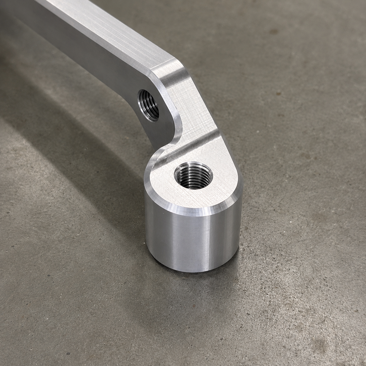 Close up of the machining detail on the GR Yaris Small Brake Kit caliper mounting adapter