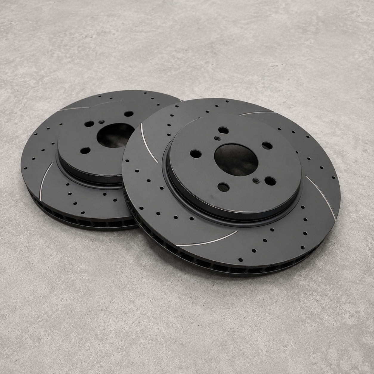 Replacement brake discs for Neomatic GR Yaris Small Brake Kit showing drilled, slotted and ventilated 314 mm brake rotors