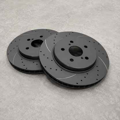 Replacement brake discs for Neomatic GR Yaris Small Brake Kit showing drilled, slotted and ventilated 314 mm brake rotors