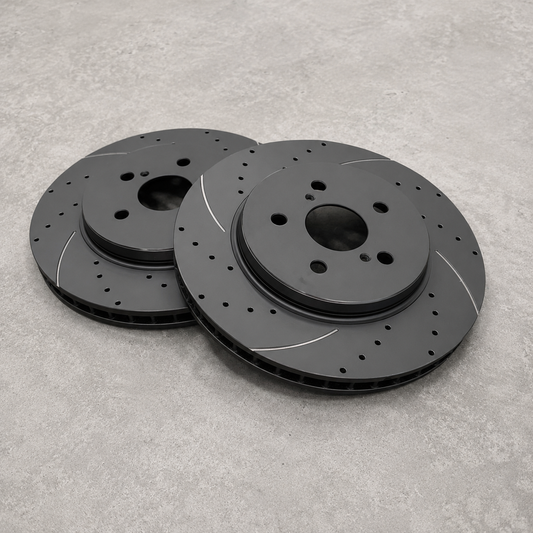Replacement brake discs for Neomatic GR Yaris Small Brake Kit showing drilled, slotted and ventilated 314 mm brake rotors