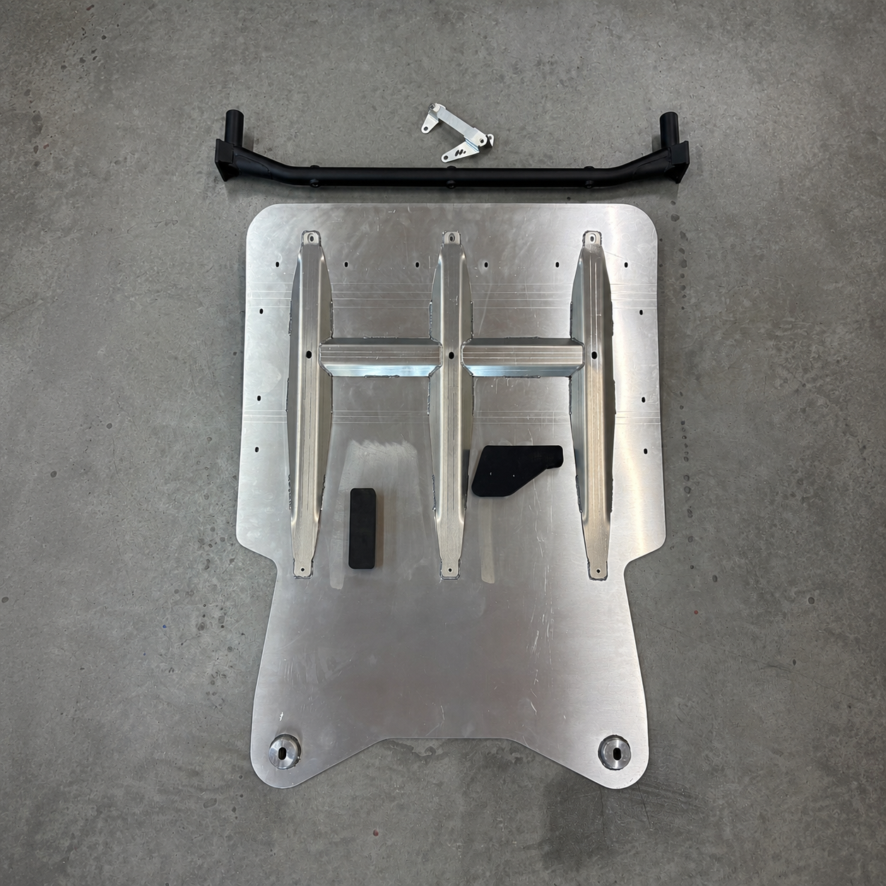 Gen2 GR Yaris skid plate underside with welded reinforcement ribs and protective foam pads for engine oil sump and gearbox