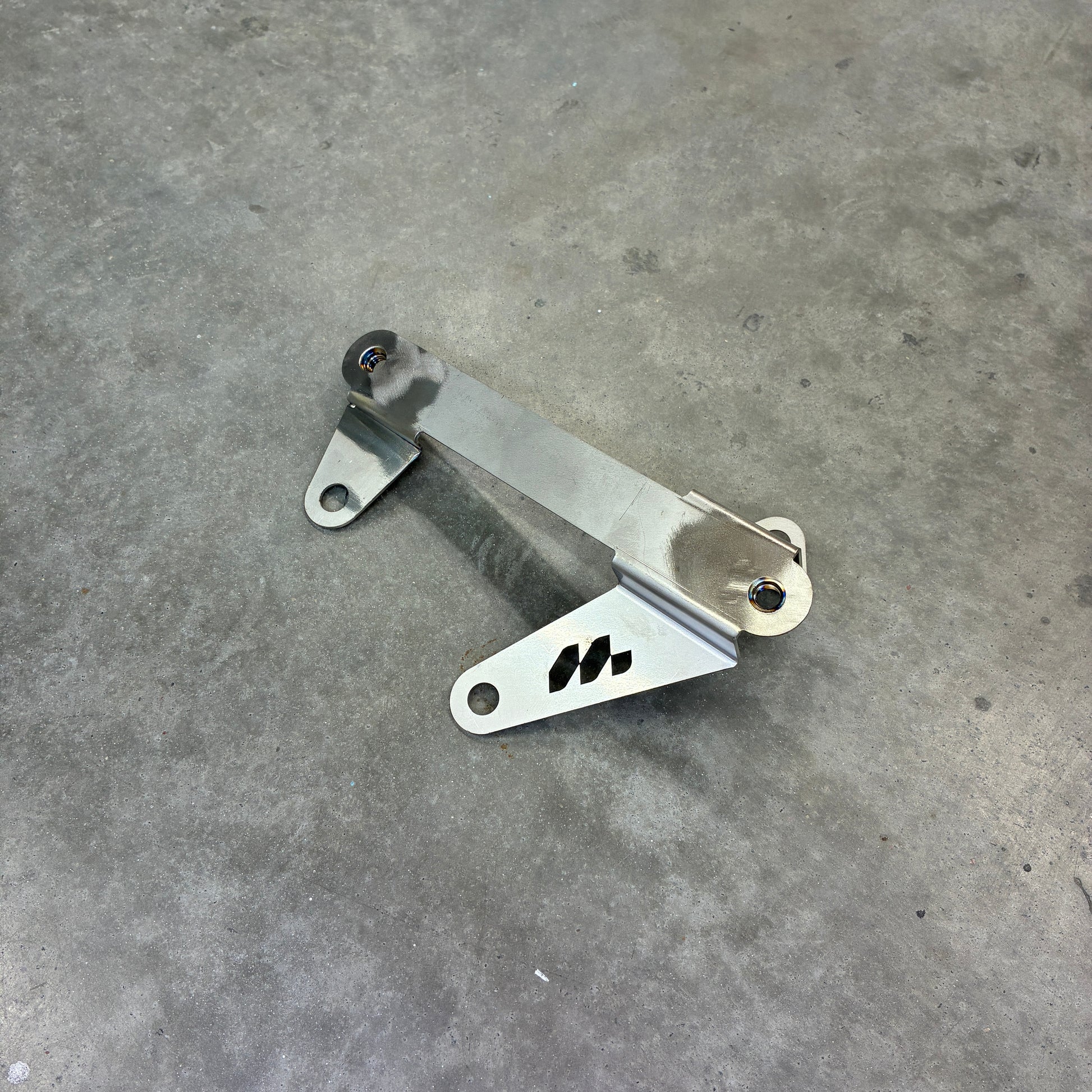 Gen2 GR Yaris stainless steel gearbox cooler relocation bracket included with Neomatic sump guard and skid plate kits